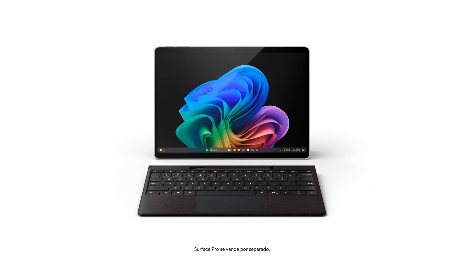 Una tableta con teclado sobre una superficie blanca, la pantalla muestra una imagen abstracta colorida.