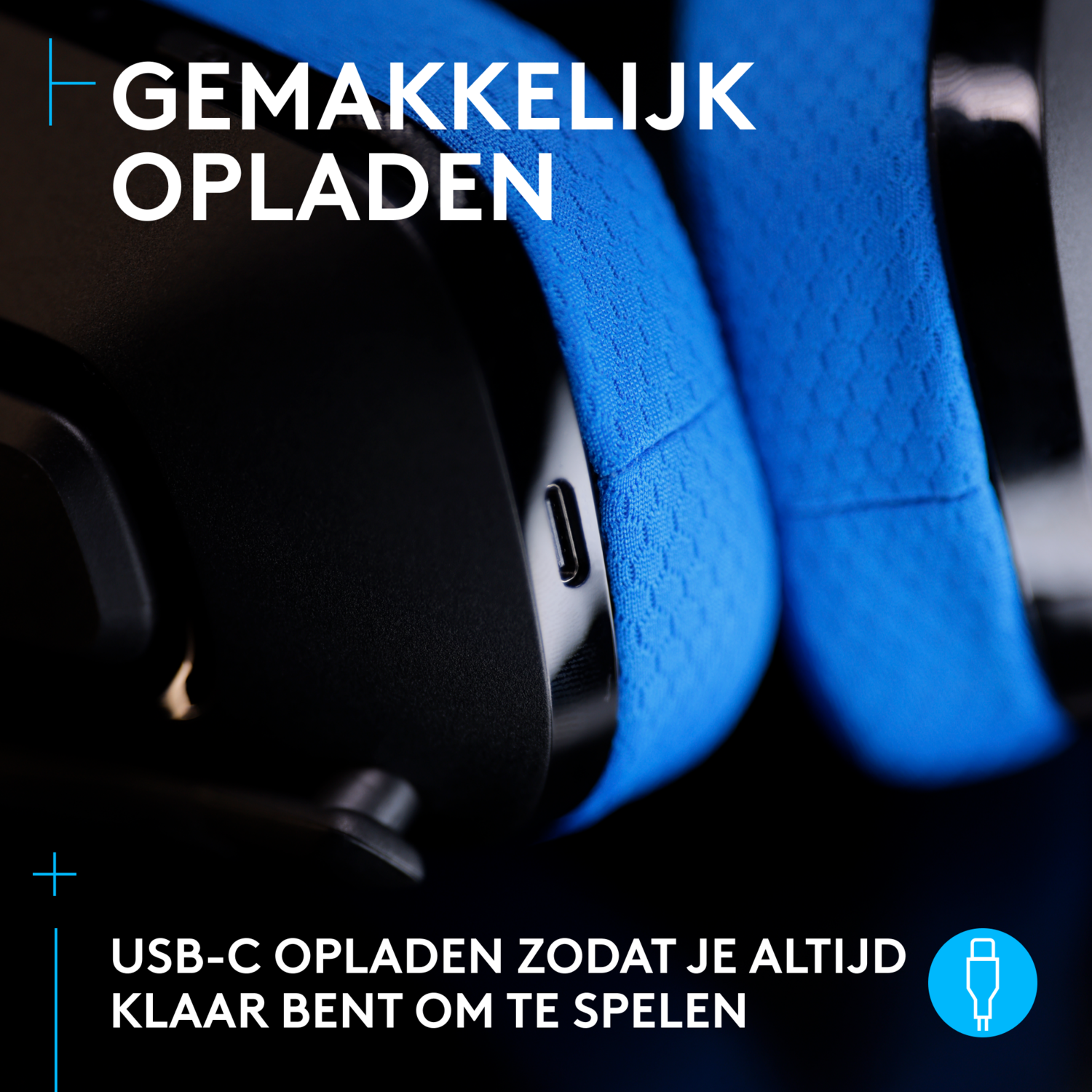 Close-up of a black and blue gaming headset with a USB-C charging port.