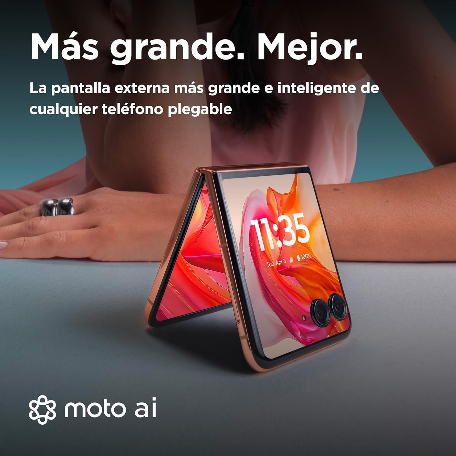 Teléfono plegable abierto con marco dorado, mostrando la hora en pantalla y texto arriba.