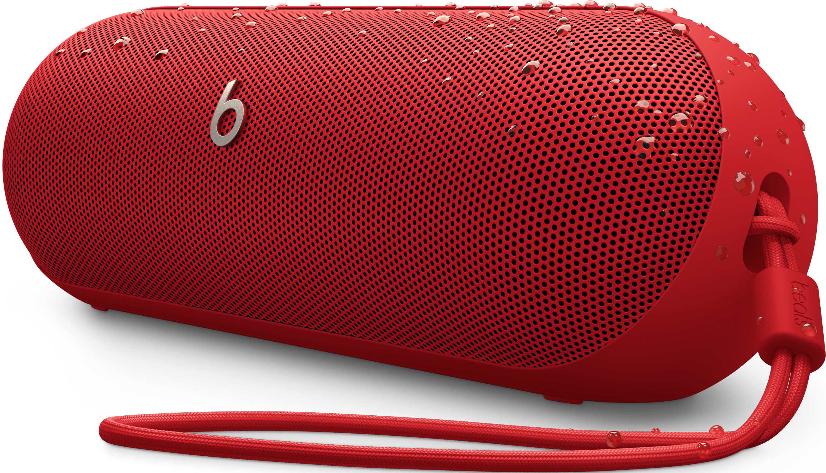 Enceinte Beats rouge avec des gouttelettes d'eau. Sangle rouge.