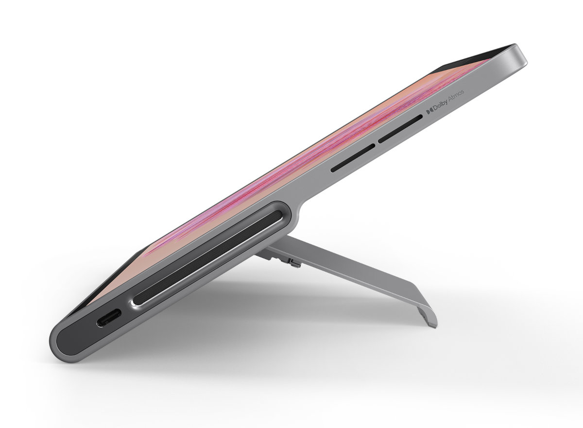 Srebrny tablet z różowym ekranem, podparty podpórką, widok z boku.