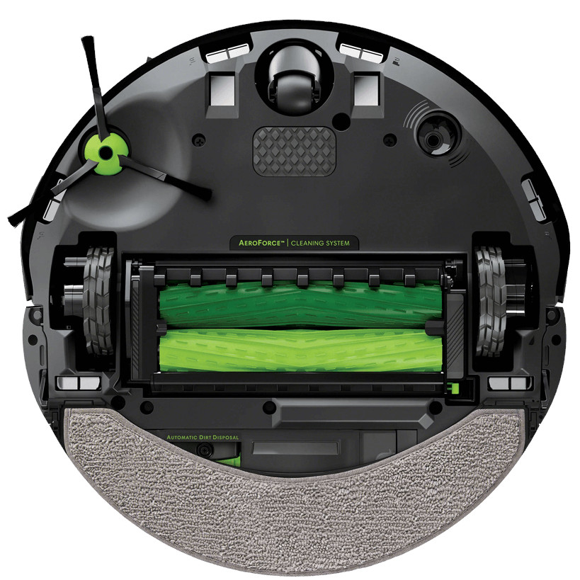 Widok od spodu robota sprzątającego, pokazujący szczotki, koła i obszar usuwania brudu. Tło jest białe.