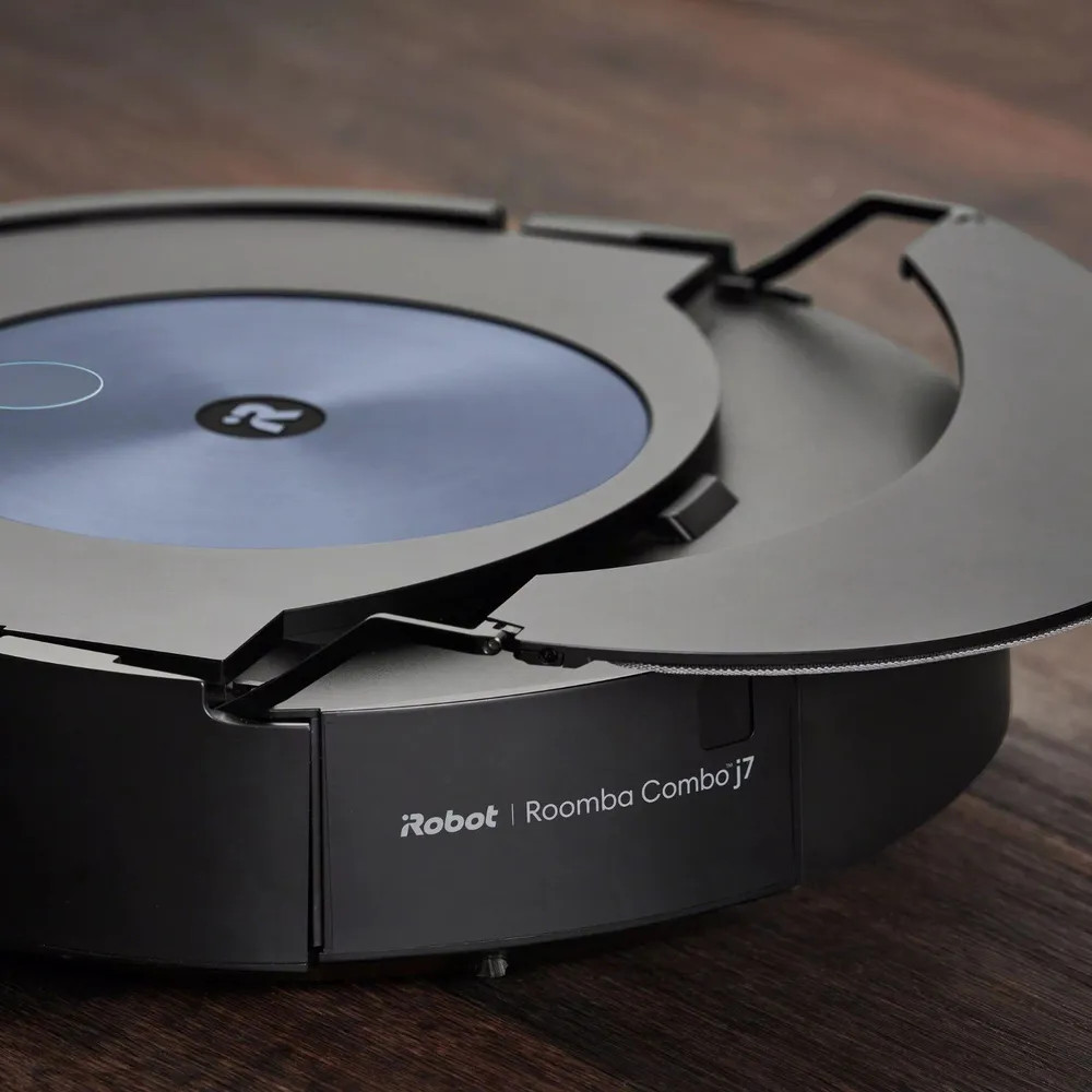 Ciemnoszary odkurzacz robot Roomba Combo j7 na drewnianej podłodze.