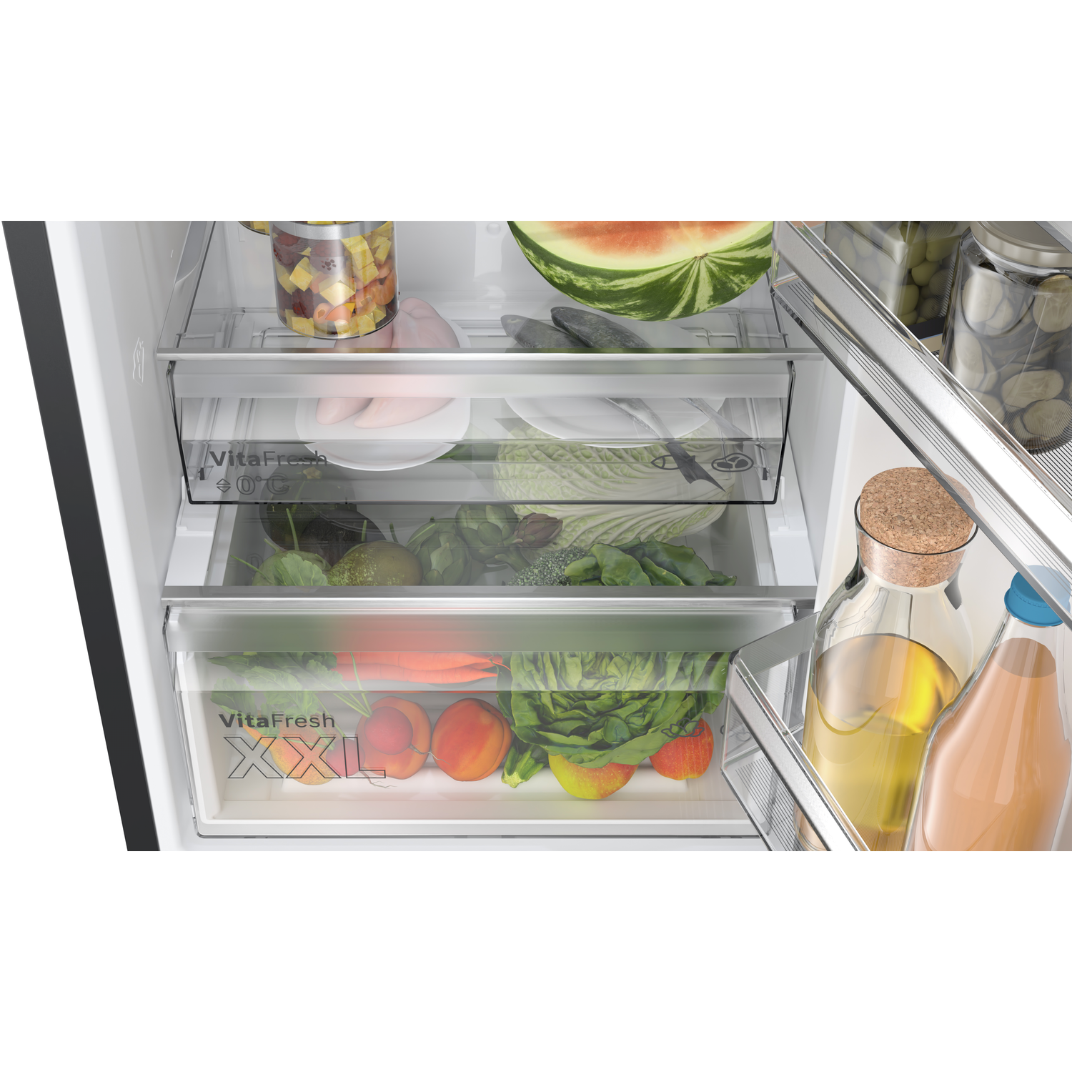 Refrigerator interior. Three drawers filled with produce, including fruits, vegetables, and packaged food items.