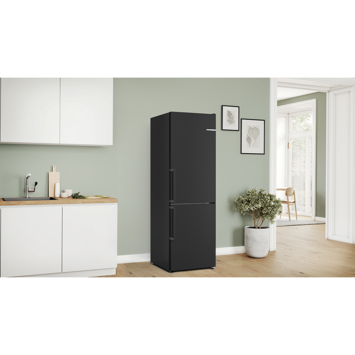 A black refrigerator with two doors, set in a kitchen with wooden cabinets.