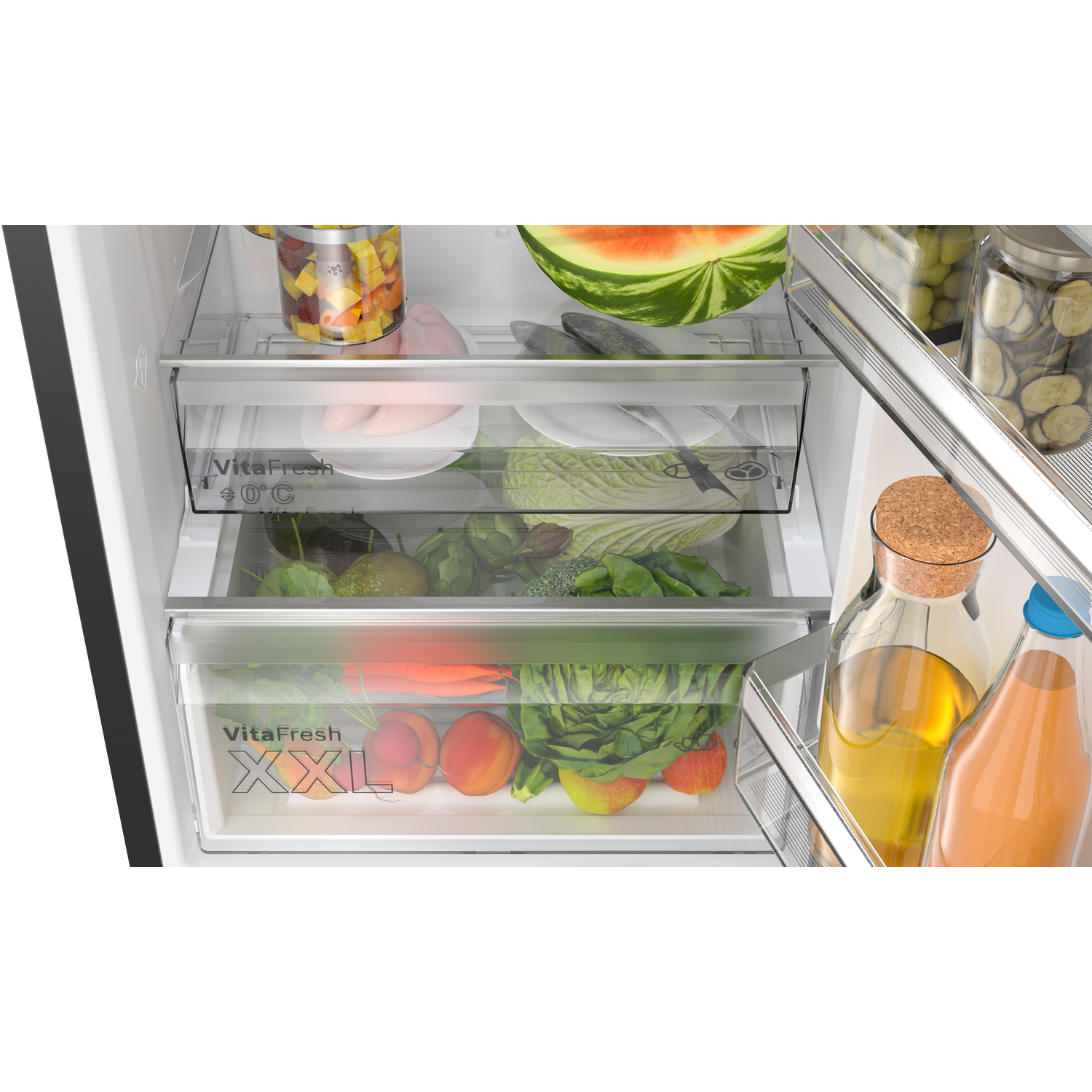 Refrigerator interior. Vegetables and fruits are stored in drawers. Glass bottles and jars are visible.