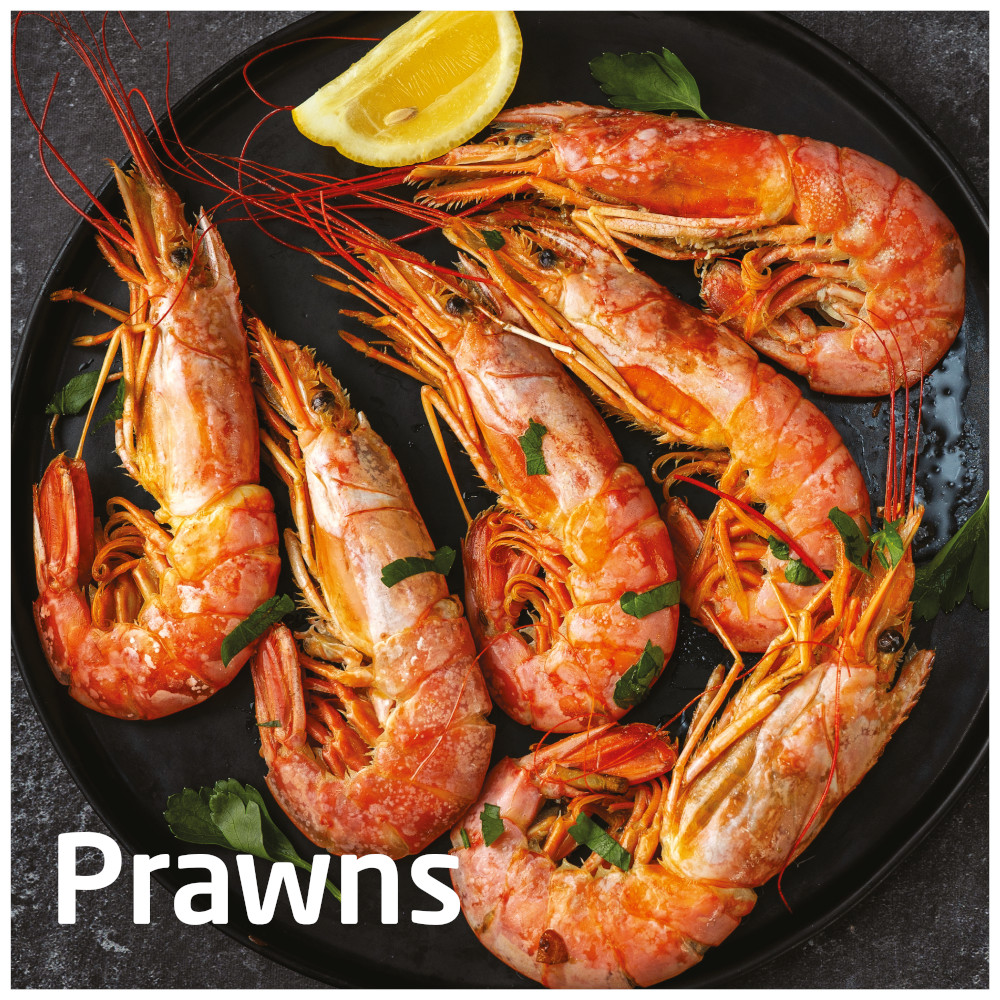 Cooked prawns on a black plate with lemon and text "Prawns".