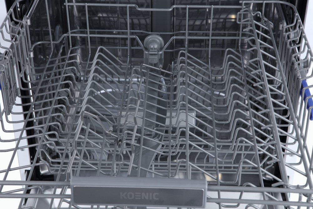 Dishwasher interior with racks. Metallic racks show the structure for holding dishes and utensils.