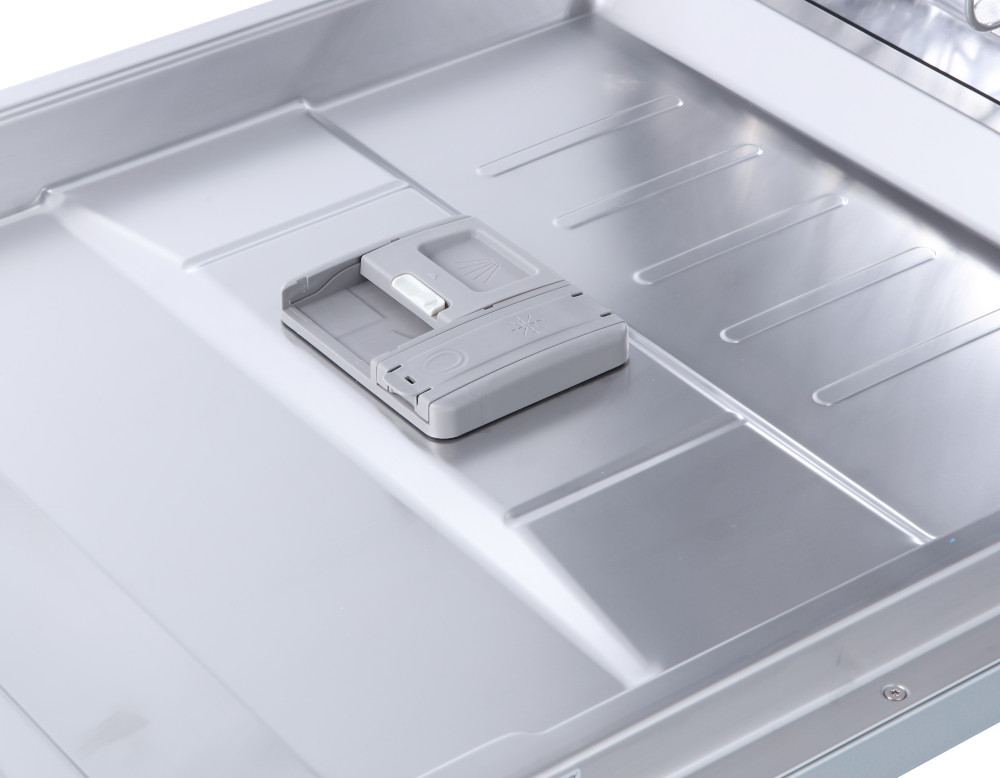 Dishwasher tray with gray dispenser inside.