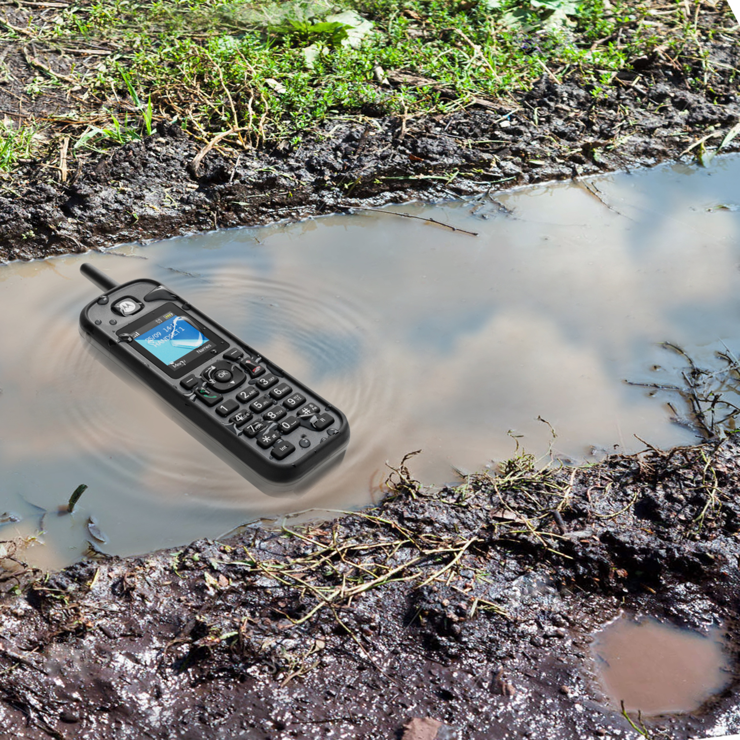 Téléphone noir étanche immergé dans de l'eau boueuse. L'écran est visible, affichant un écran.