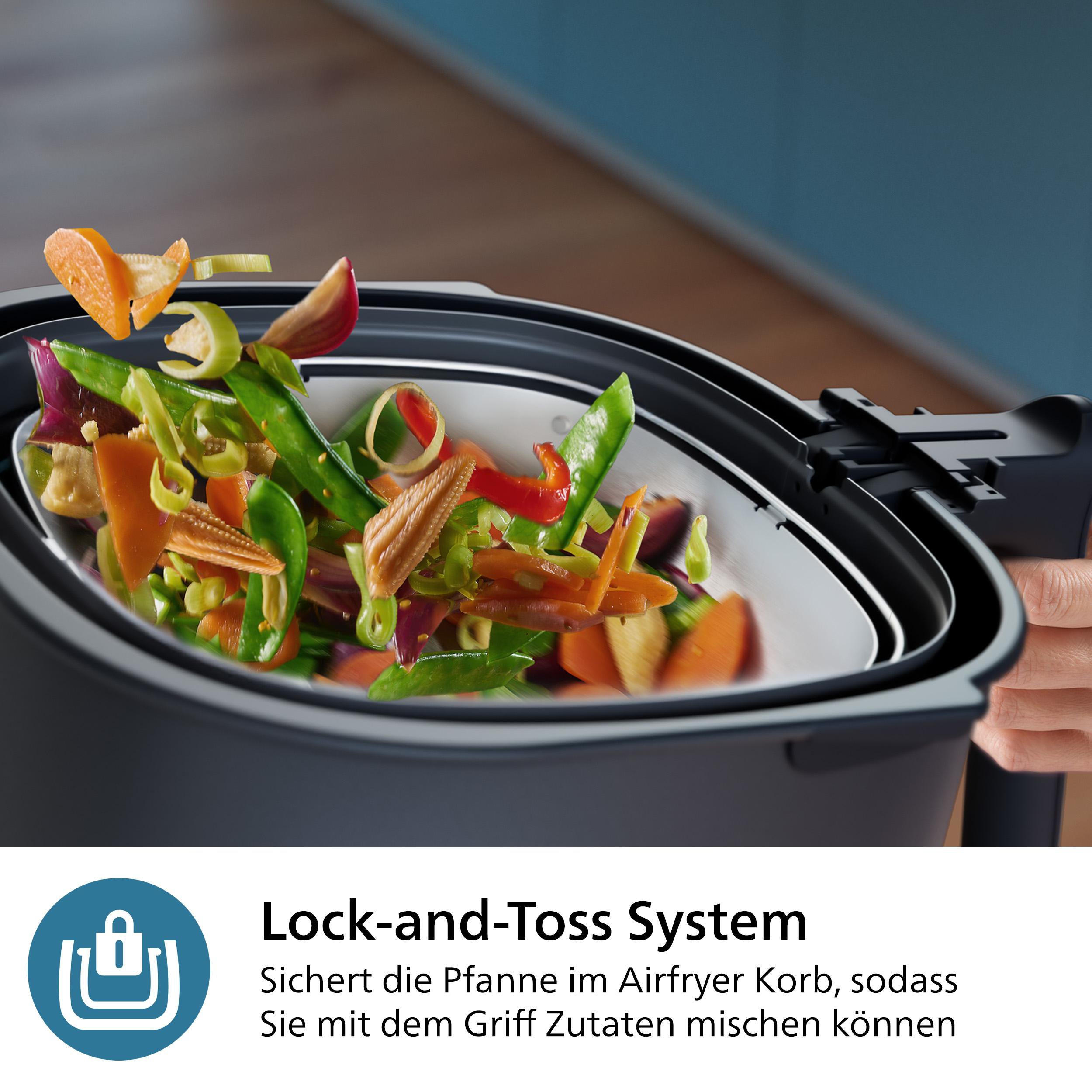Airfryer-Korb mit Gemüse, das das Lock-and-Toss-System zeigt.