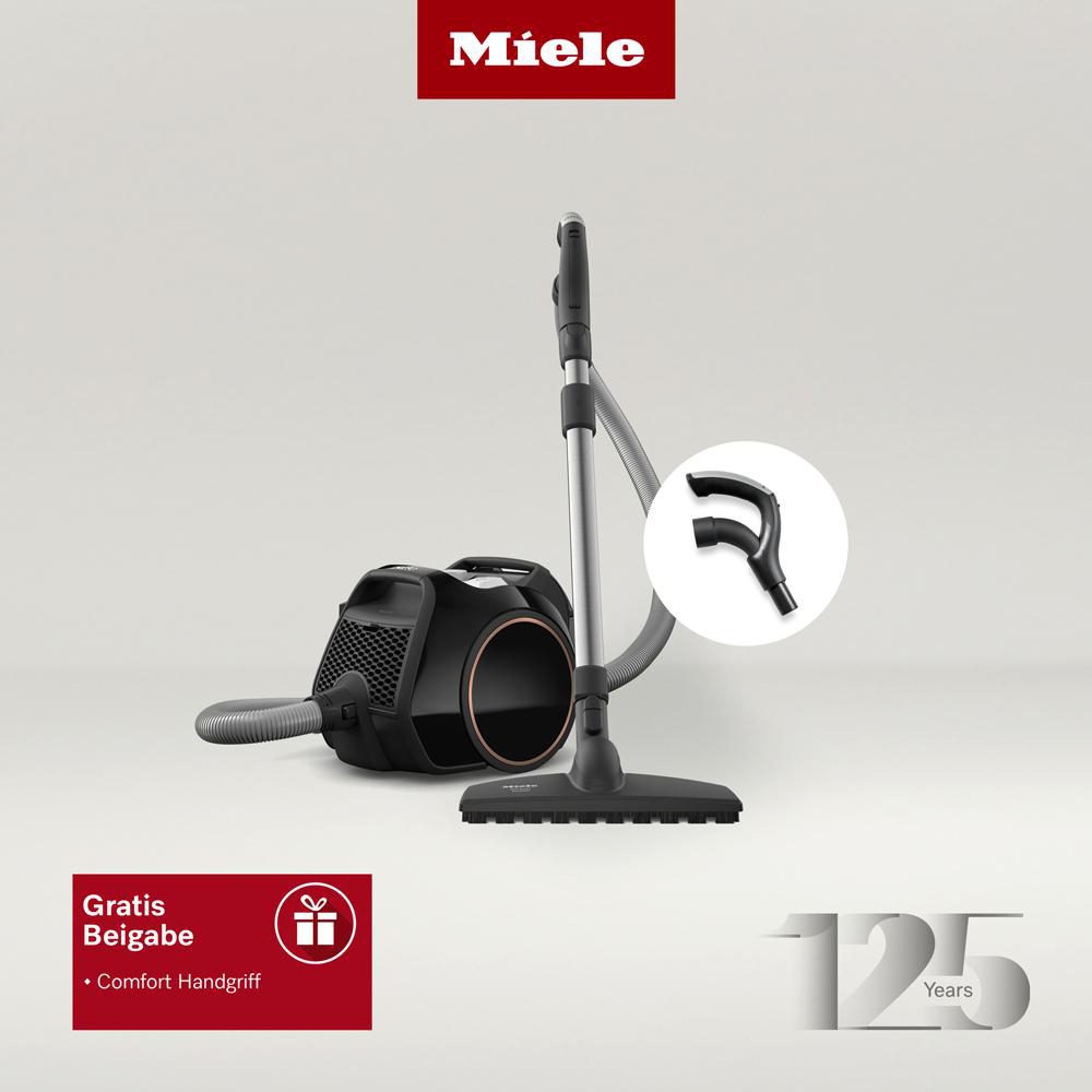 Miele Staubsauger mit Zubehör, mit Geschenkbox und Text.