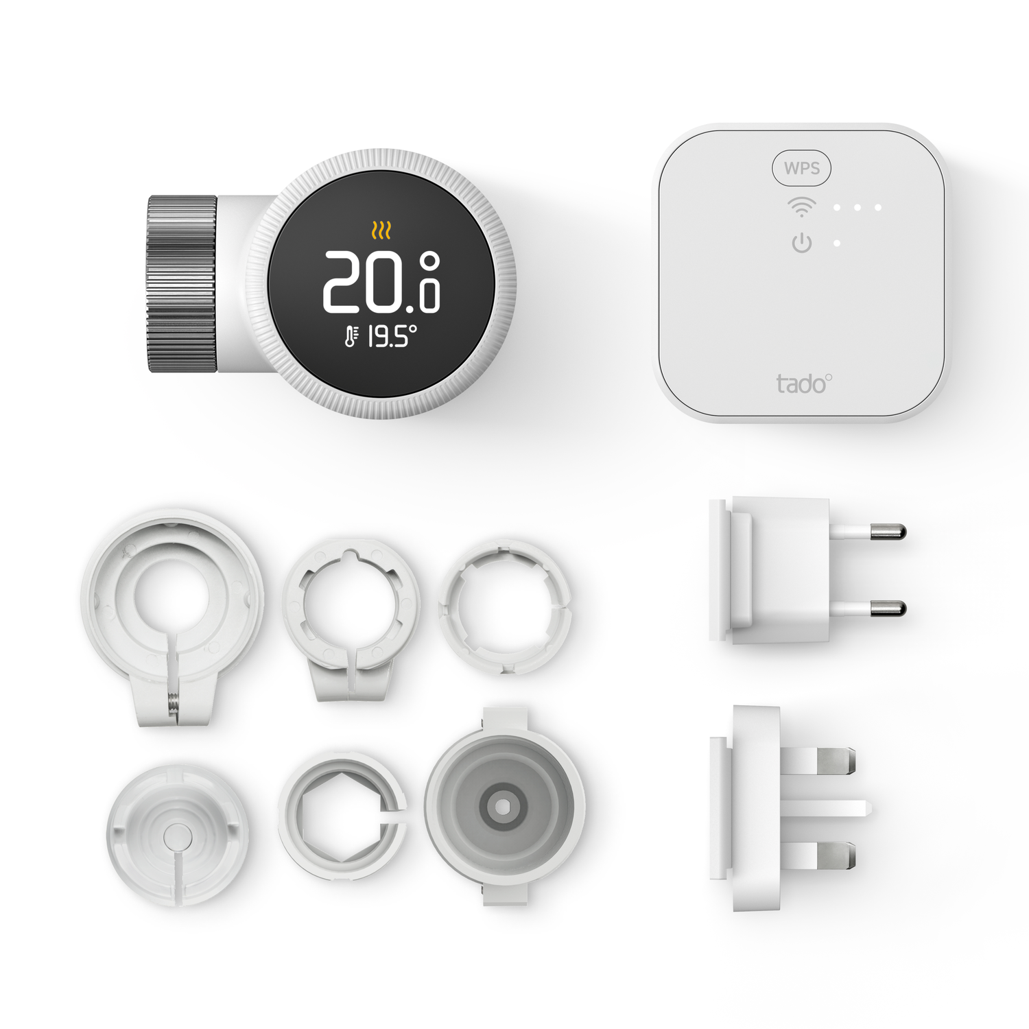 Tado smart thermostat and accessories. Includes the thermostat, a control unit, various adapters, and plugs.