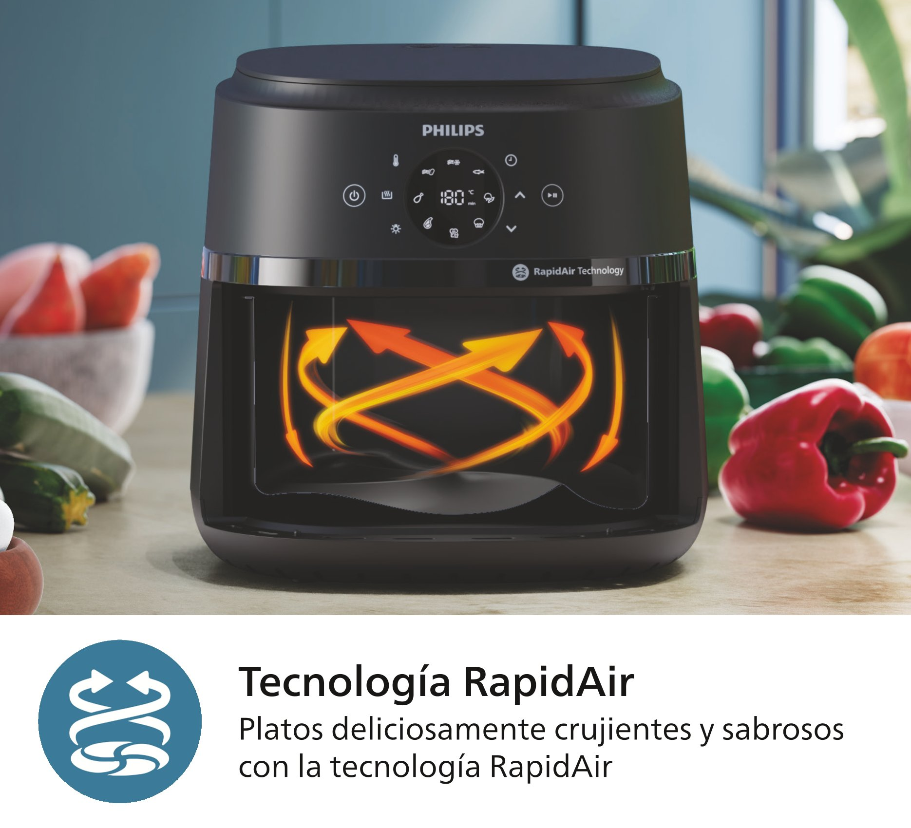 Una freidora de aire negra con pimiento rojo y calabacín verde.