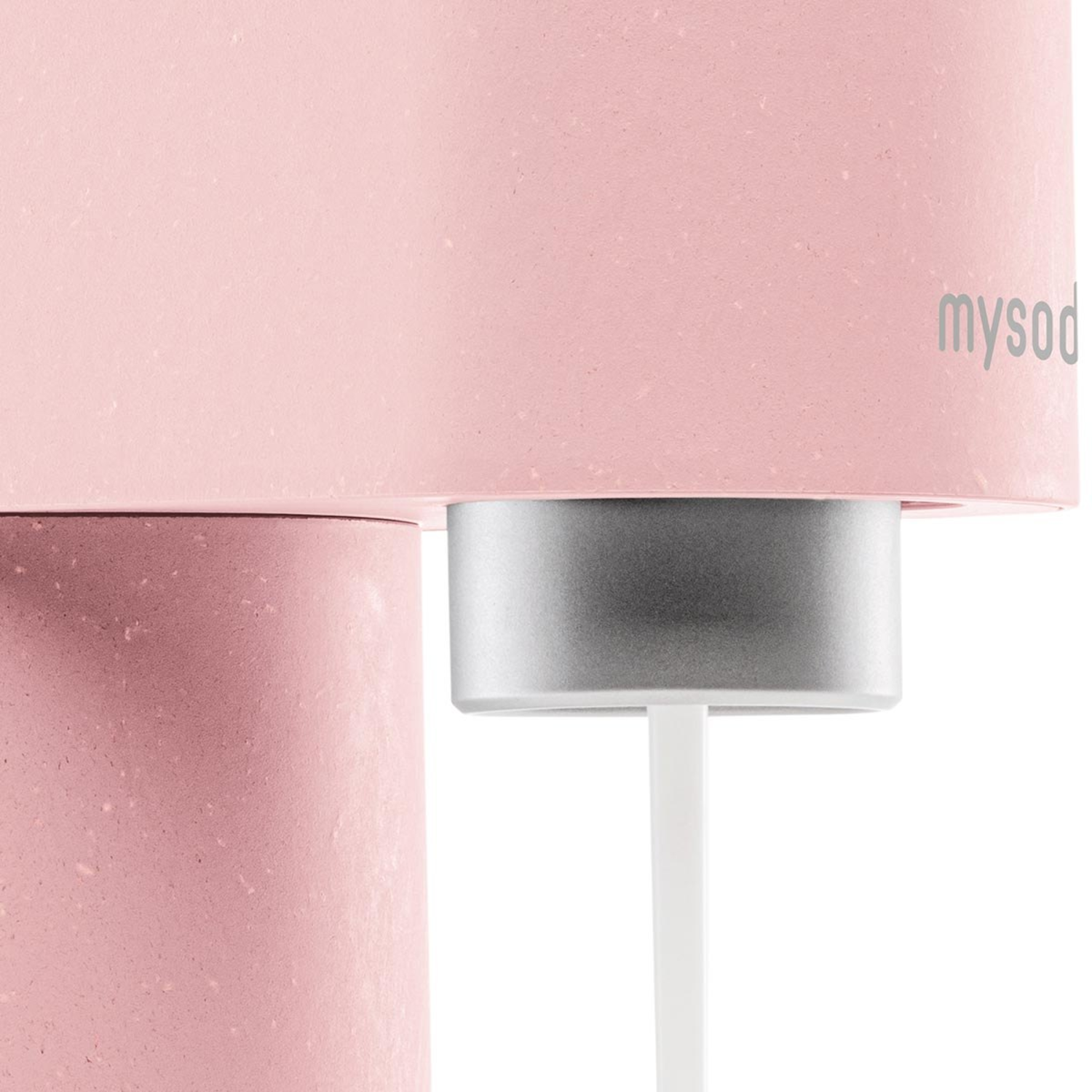 Close-up of a pink soda maker with a silver detail.