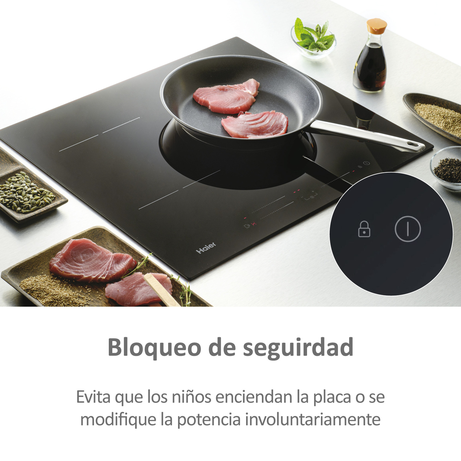 Placa de inducción negra con sartén, comida e icono de bloqueo de seguridad.