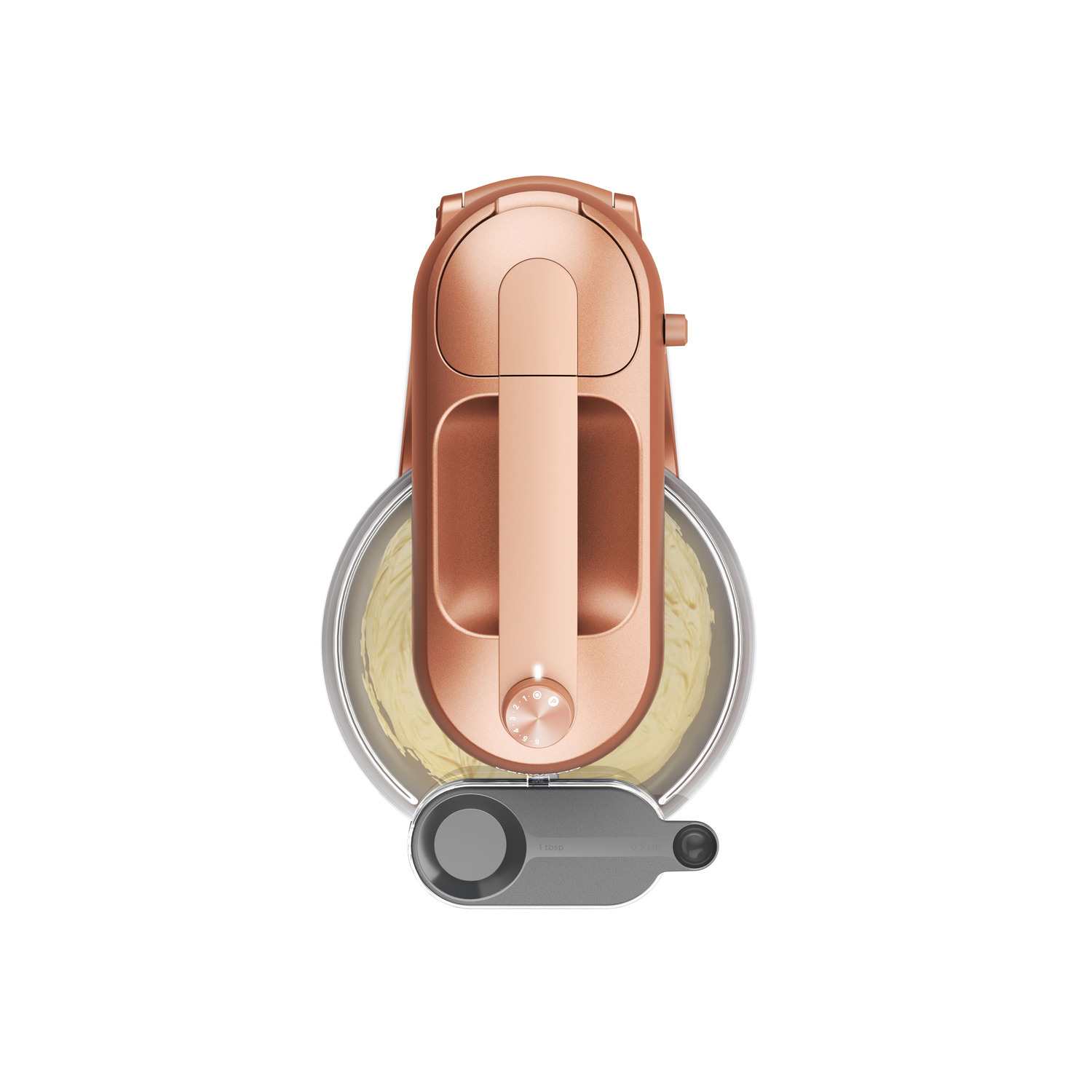Top-down view of a copper-colored stand mixer. It has a bowl with batter inside.