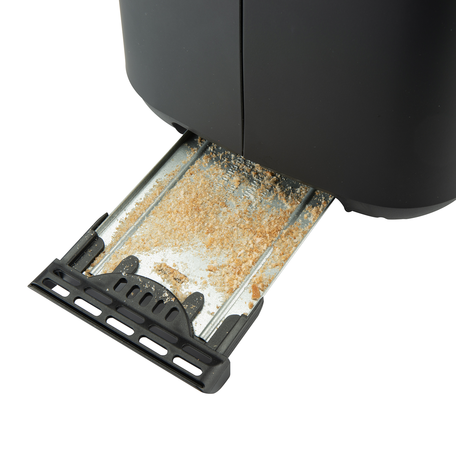 Close up of a black toaster's crumb tray, which is full of crumbs.