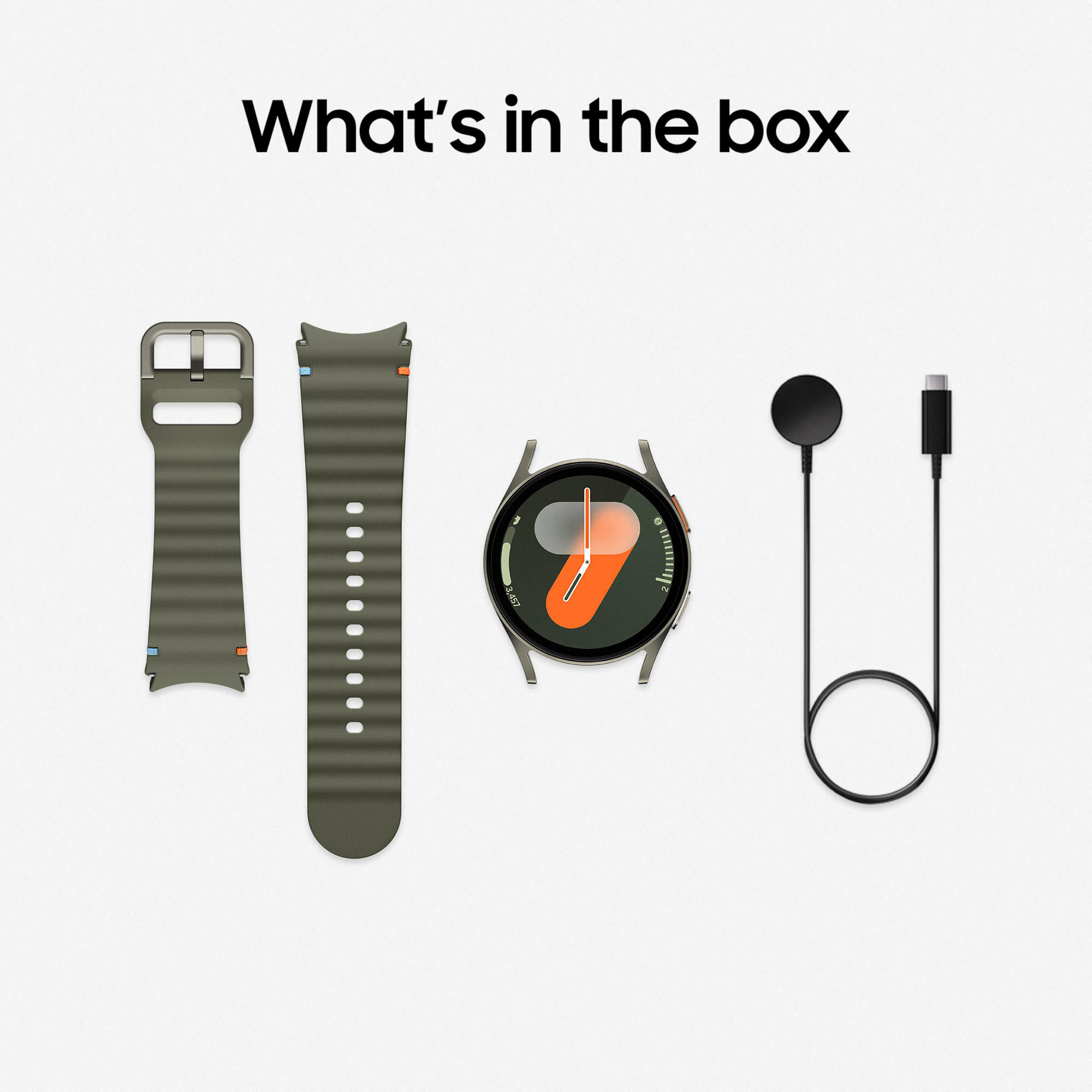 Smartwatch, Armband, Ladegerät und Kabel auf weißer Oberfläche.
