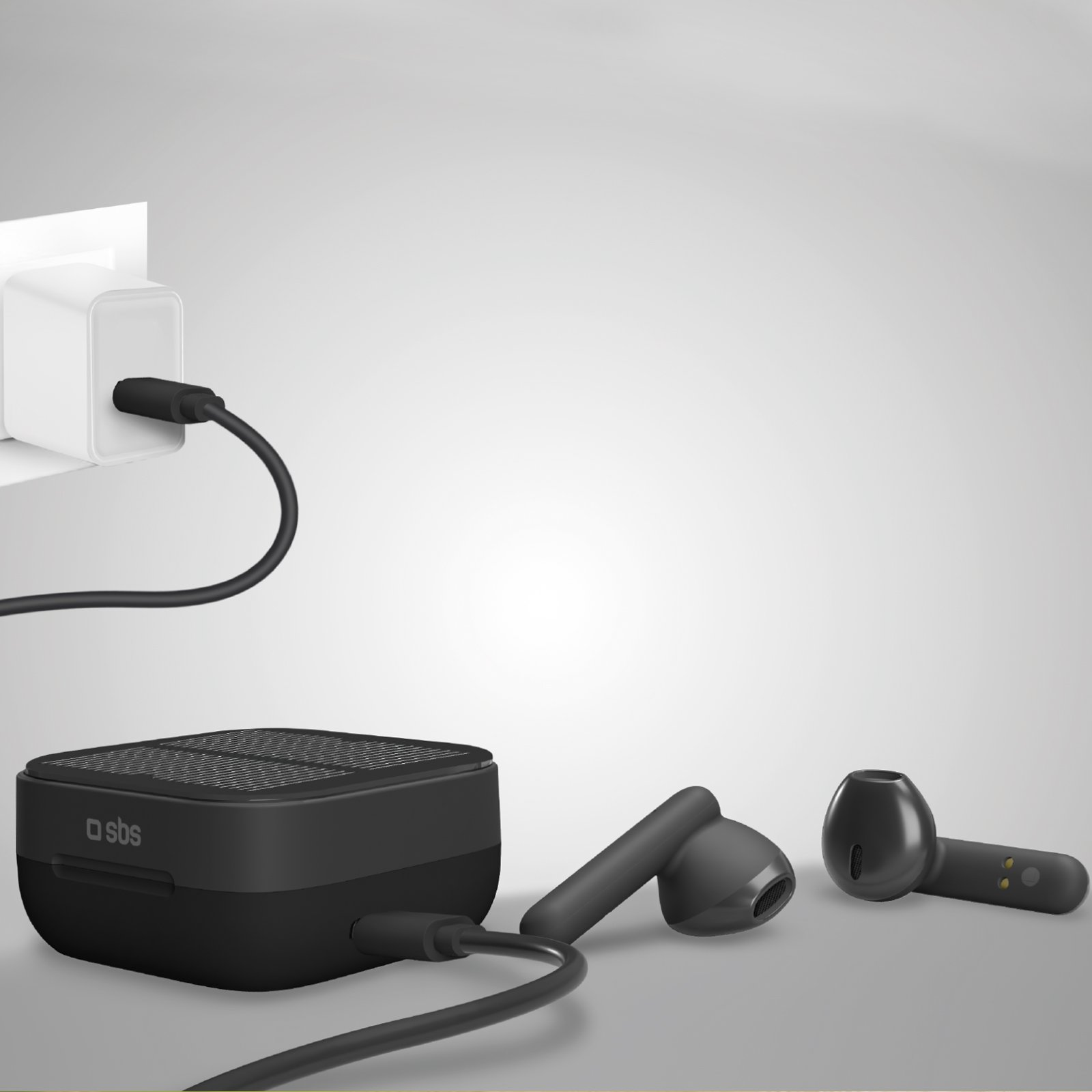 Czarna ładowarka, słuchawki i etui ładujące na jasnoszarej powierzchni.