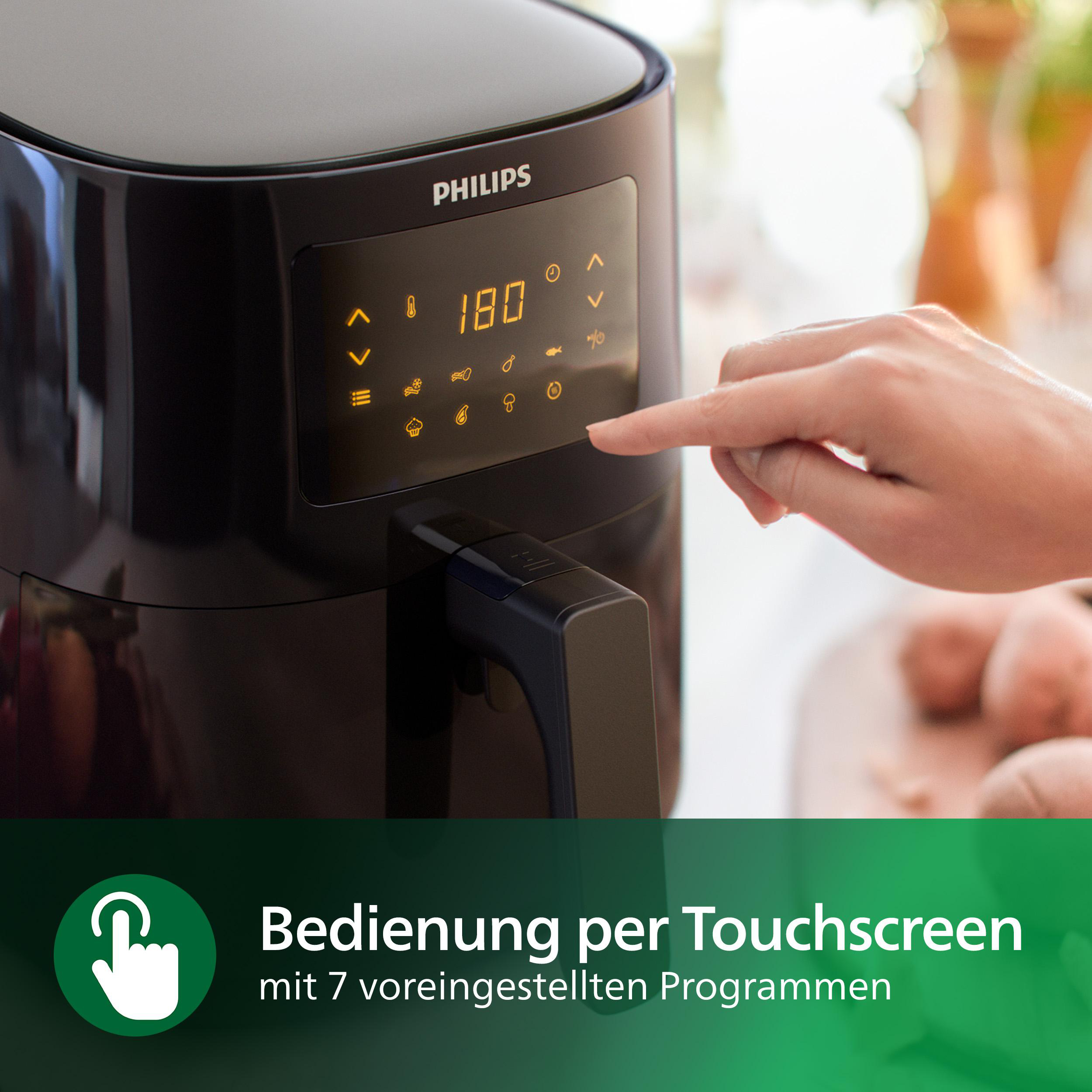Schwarze Philips Heißluftfritteuse mit Touchscreen, zeigt 180 Grad. Hand zeigt auf den Bildschirm.