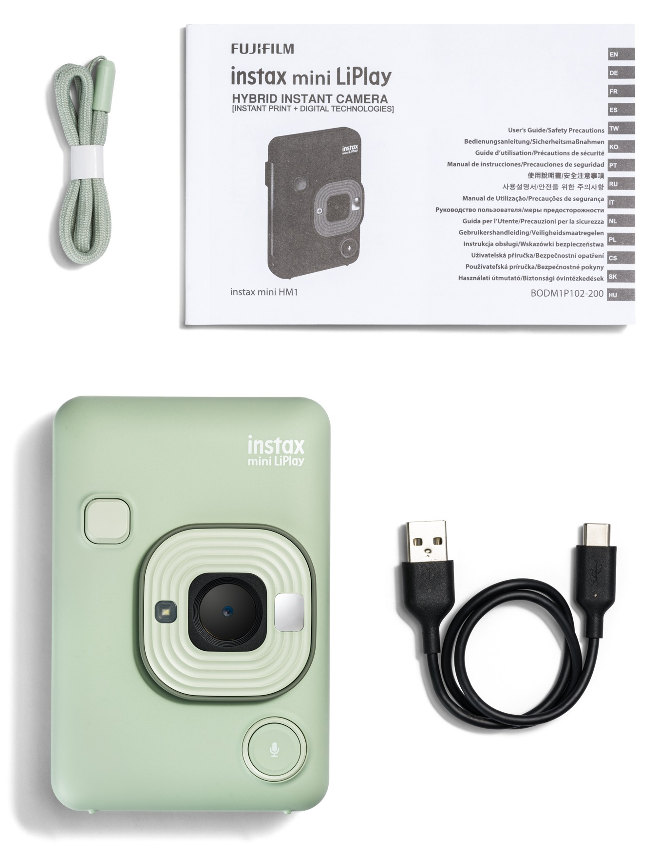 Zielony zestaw aparatu natychmiastowego z akcesoriami i instrukcją obsługi.