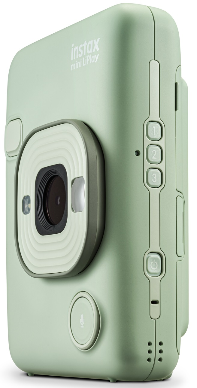 Jasnozielony aparat. Widok z boku. Ma przyciski i obiektyw.