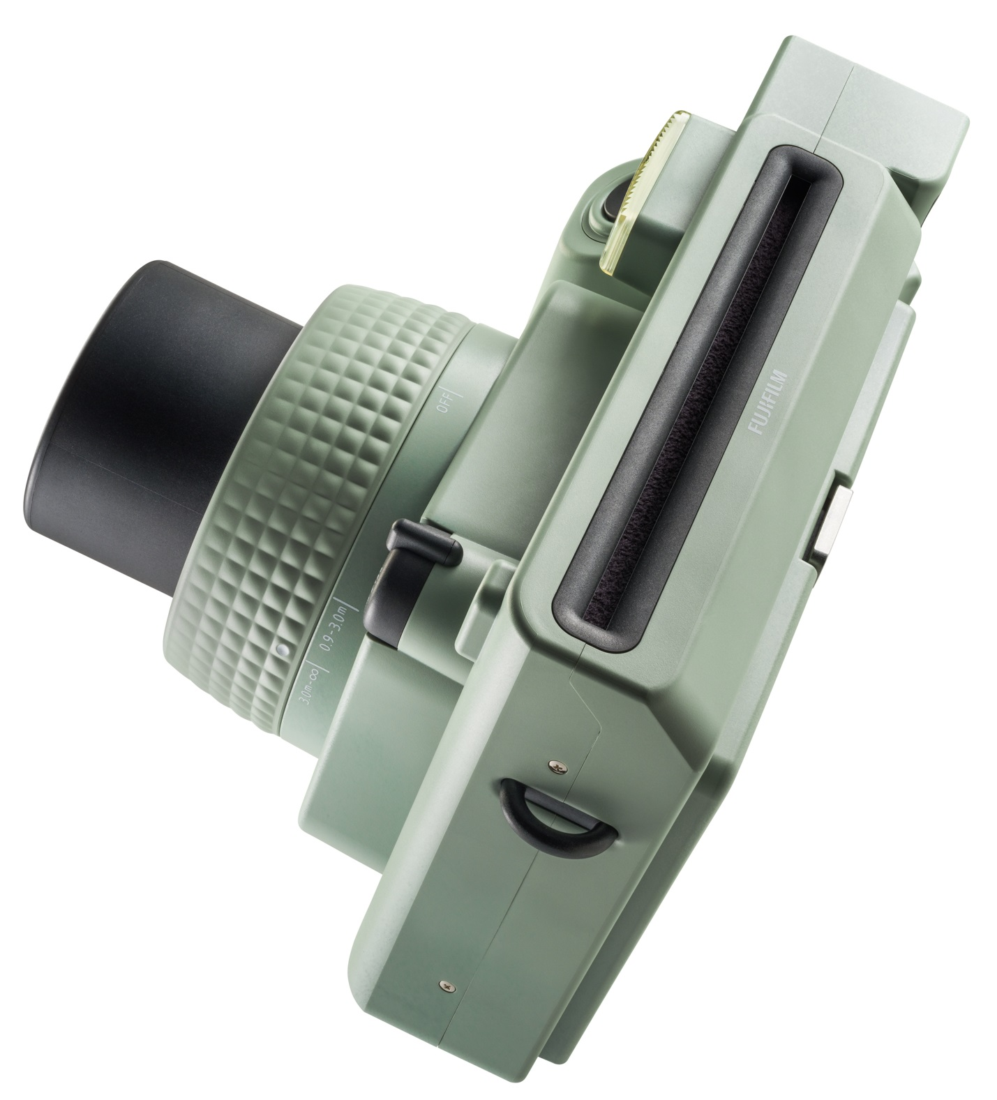 Zielony aparat natychmiastowy pod kątem, aby pokazać obiektyw i górne przyciski.