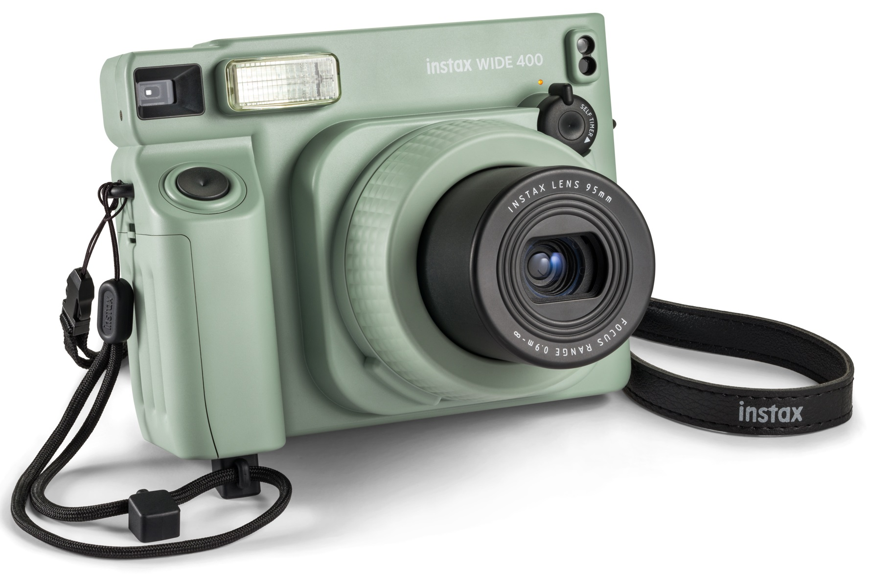 Zielony aparat retro z czarnym paskiem i obiektywem, białe tło.