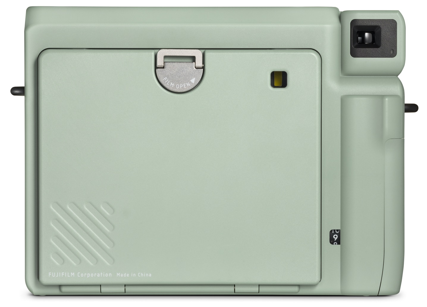 Widok z tyłu miętowo-zielonego aparatu natychmiastowego. Zawiera klapkę na film i pokrętło sterowania.