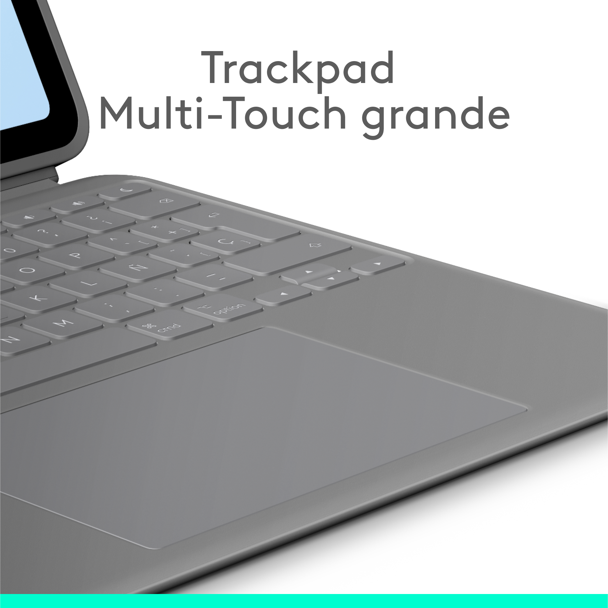 Teclado gris con trackpad. Fondo gris claro. Vista de cerca.