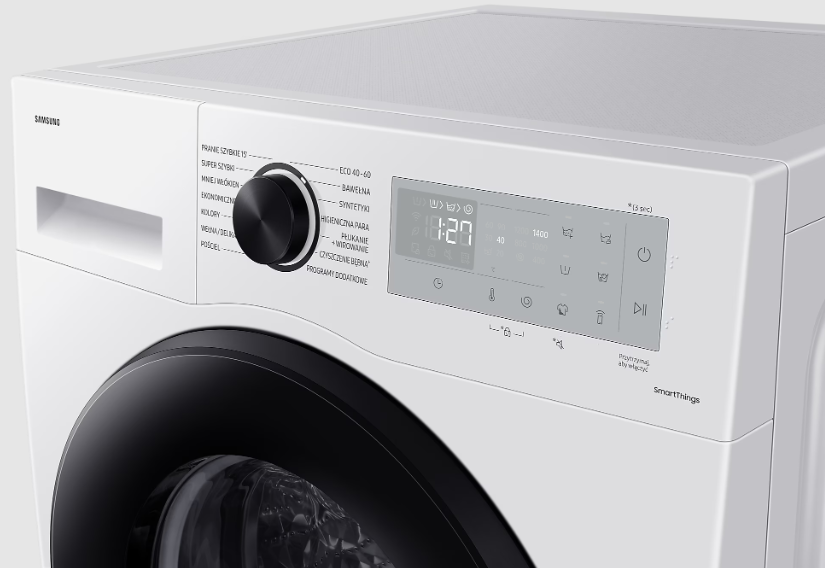 Biały panel sterowania pralki z czarnym pokrętłem i wyświetlaczem cyfrowym.