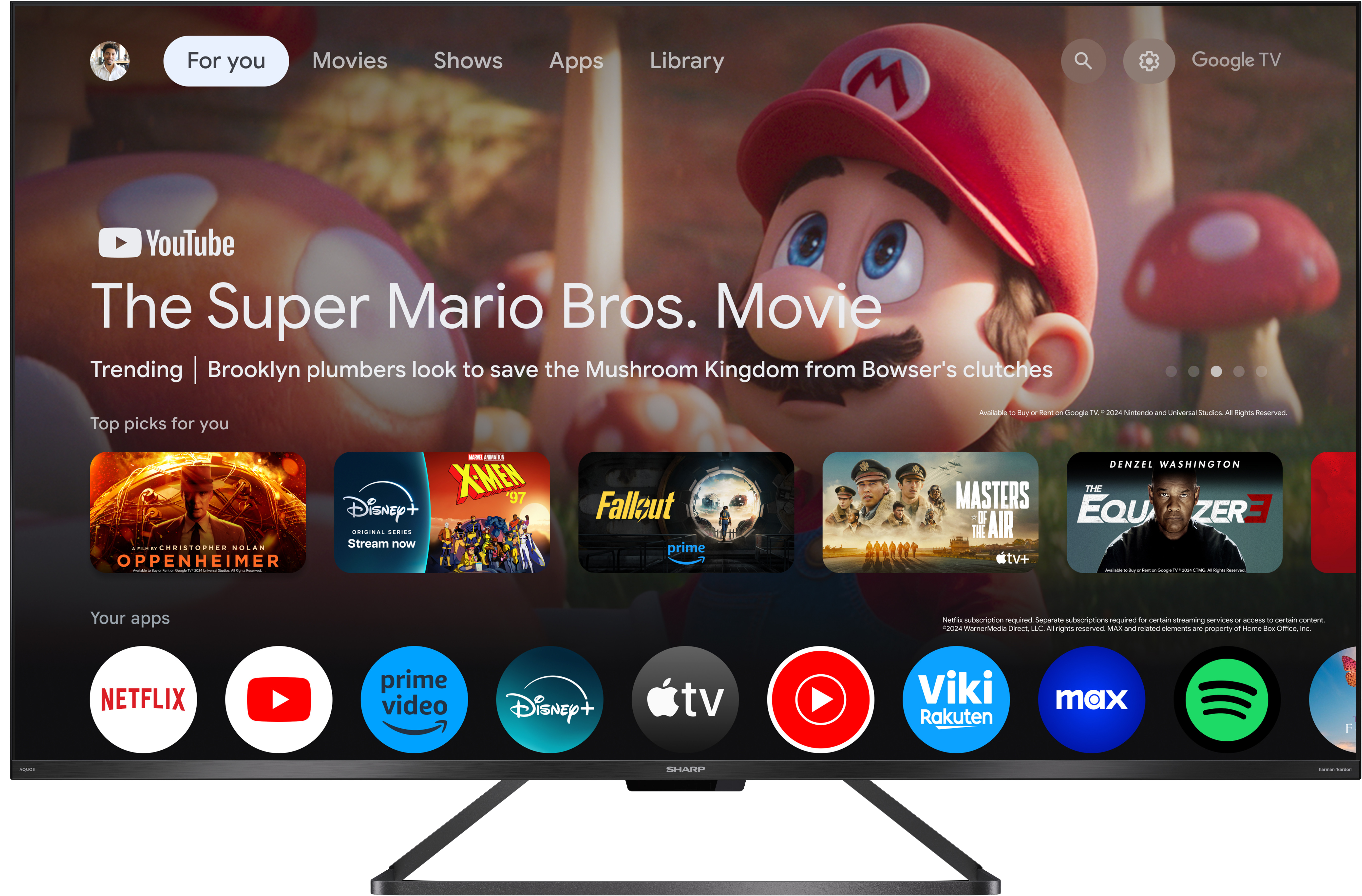 Egy lapos képernyős TV, amely egy Mario-val kapcsolatos filmjelenetet jelenít meg. Google TV felület.