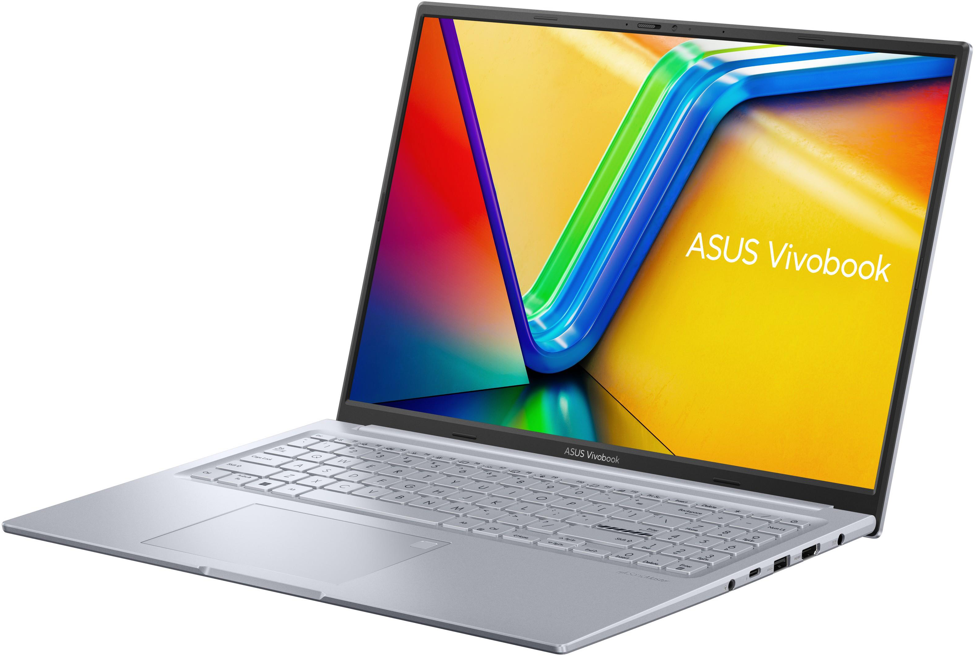 Ezüst ASUS laptop. A képernyő színes grafikát jelenít meg.