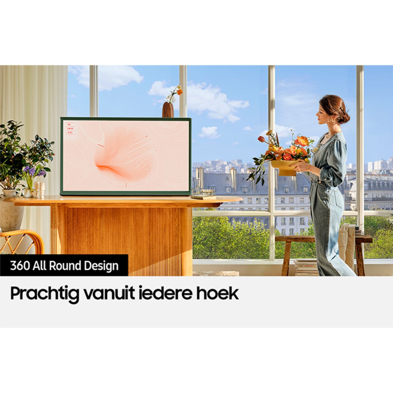 A woman standing near a window with flowers, a TV on a wooden table, and a background cityscape.