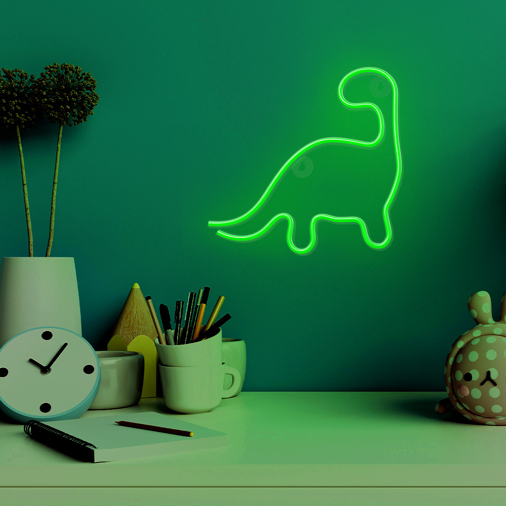 Neon zöld dinoszaurusz lámpadoboz, rózsaszín és sárga csomagolással.