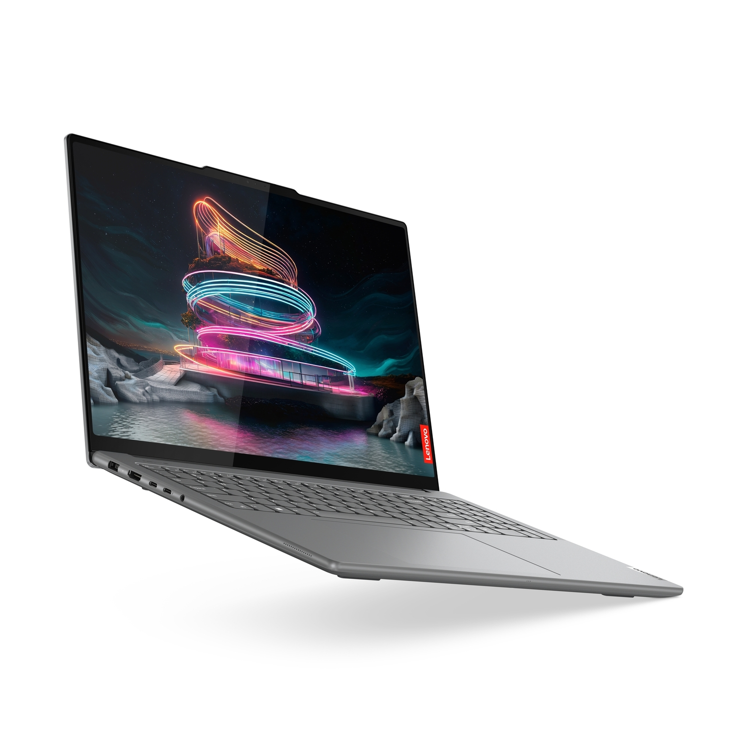 Un ordinateur portable argenté est ouvert, affichant une image abstraite colorée. Le logo Lenovo est visible.