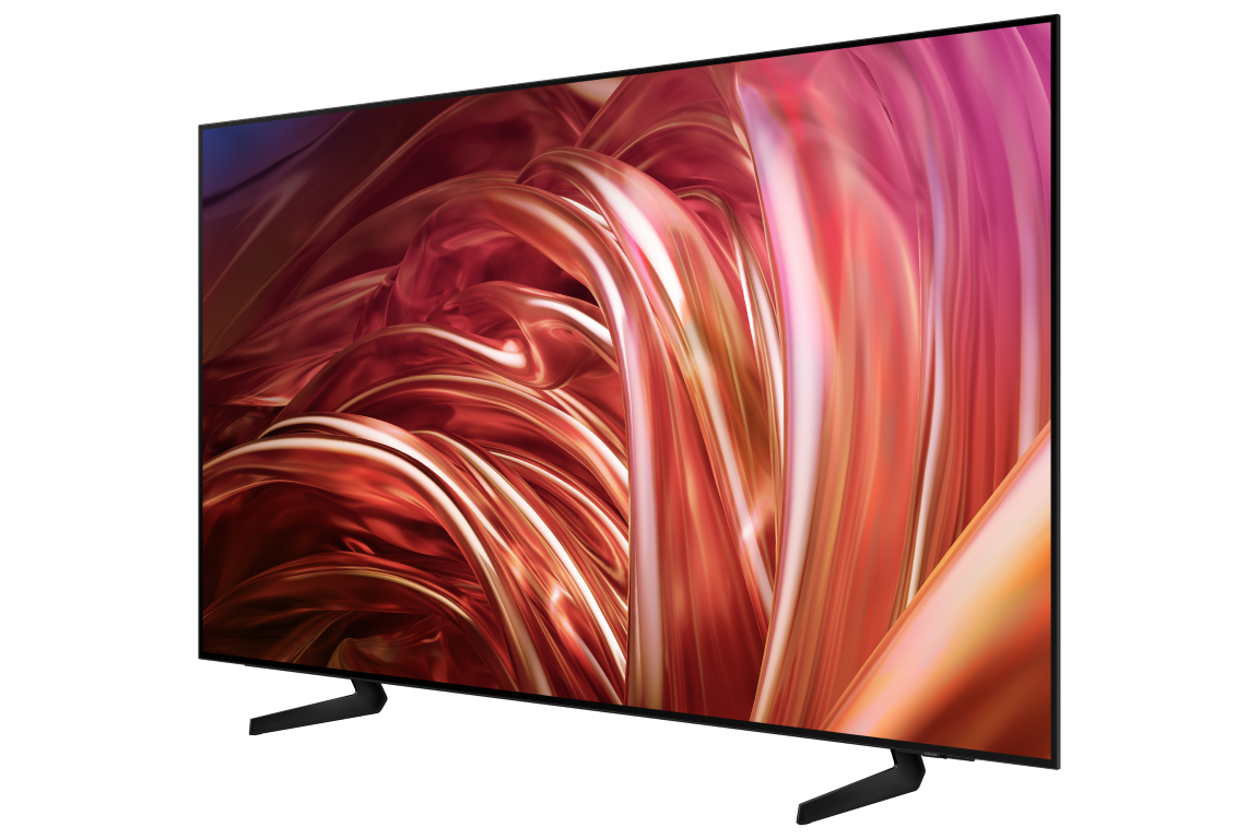 Bir stand üzerinde büyük bir TV ekranı. Ekran renkli, soyut şekiller gösteriyor. Siyah çerçeve, siyah arka plan.