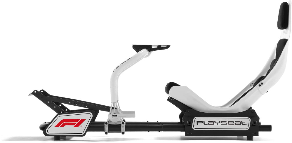 White and black Playseat racing simulator, F1 logo visible. The setup includes a seat, pedals, and a wheel mount.