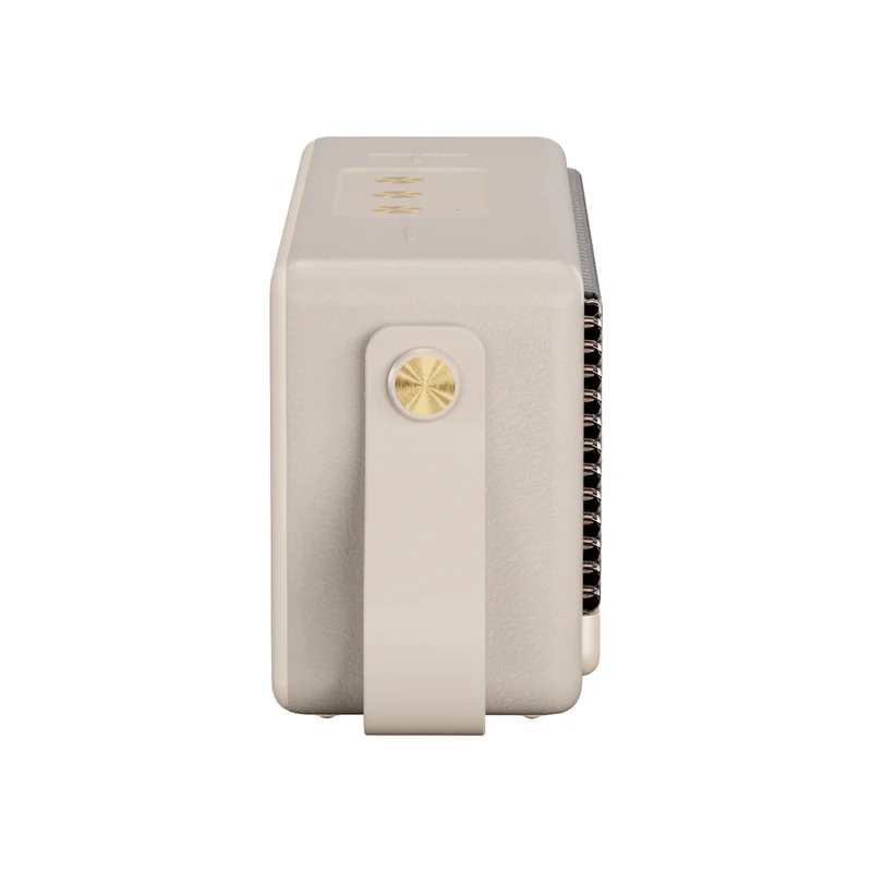 Un altavoz beige con asa. Se ve un botón dorado. El altavoz está sobre un fondo blanco.