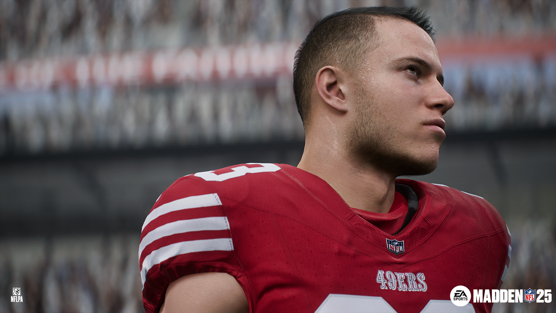 Gracz futbolu w czerwonej koszulce z logo 49ers patrzący w bok.