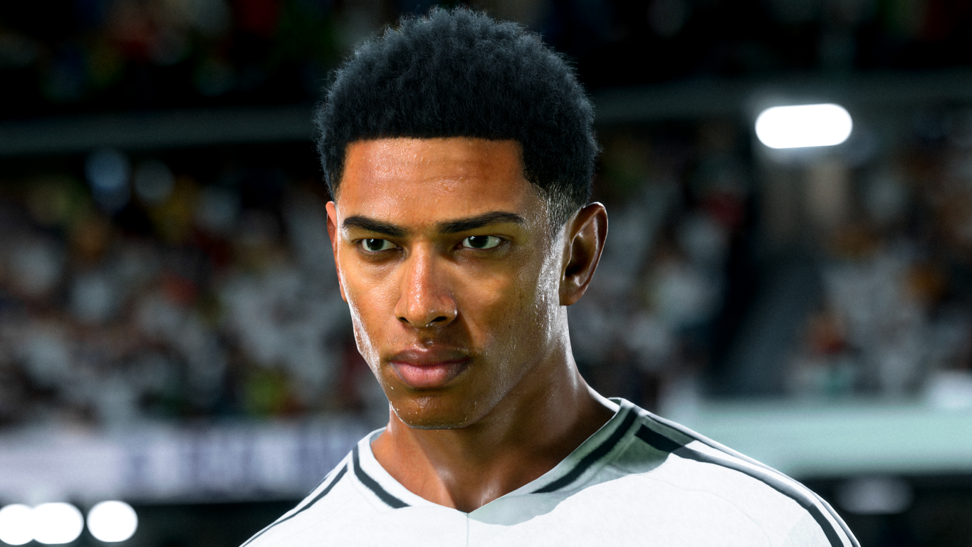 Zbliżenie na twarz mężczyzny w meczu piłki nożnej, ubranego w białą koszulkę.