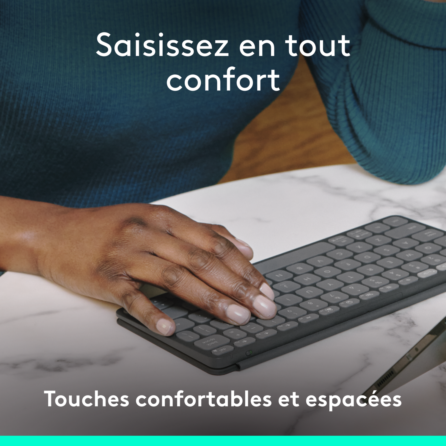 Main d'une personne sur un clavier. Texte français : "Tapez confortablement".