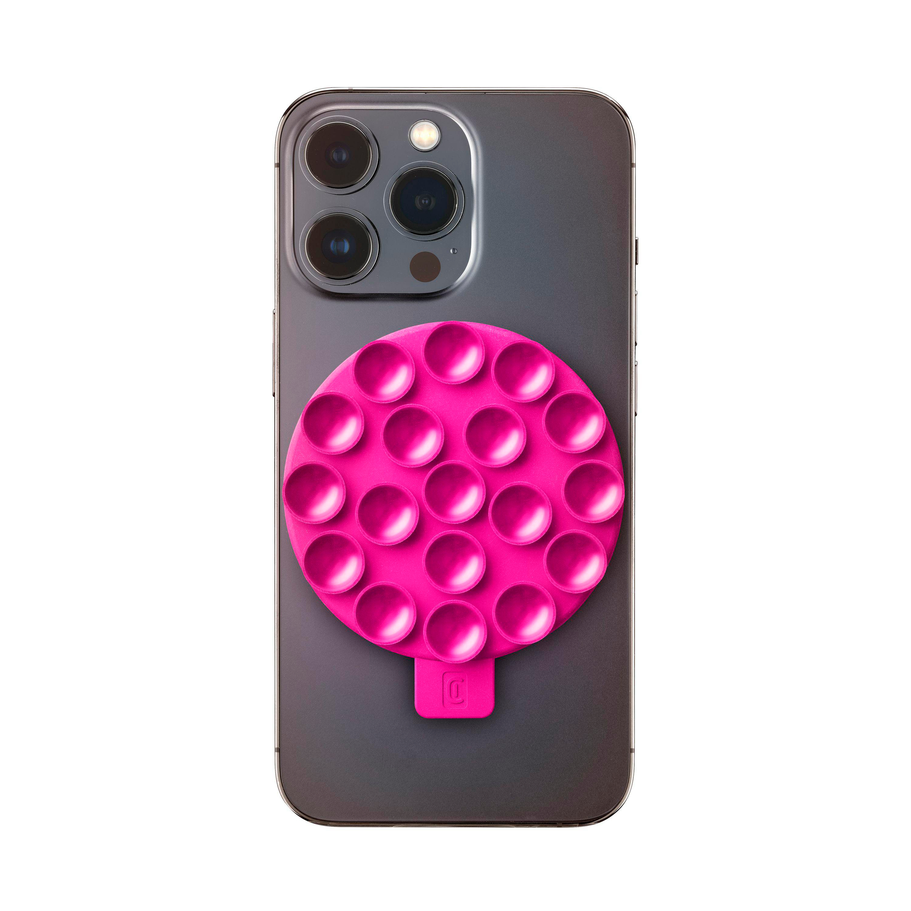 Ein rosa Handygriff mit runder, strukturierter Oberfläche, an einem grauen Telefon befestigt.