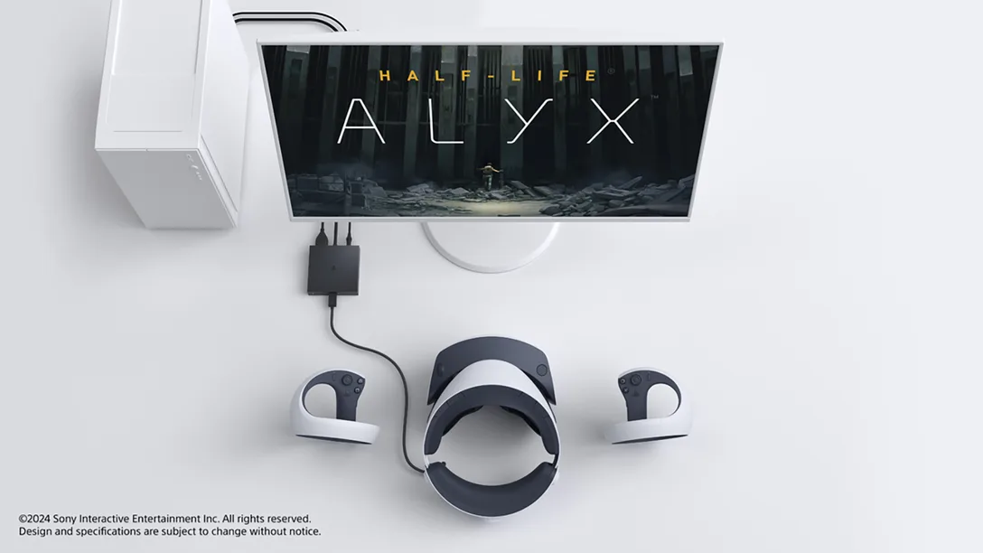 Un'installazione di gioco con un monitor che mostra Half-Life: Alyx, un visore VR, controller e una console bianca.