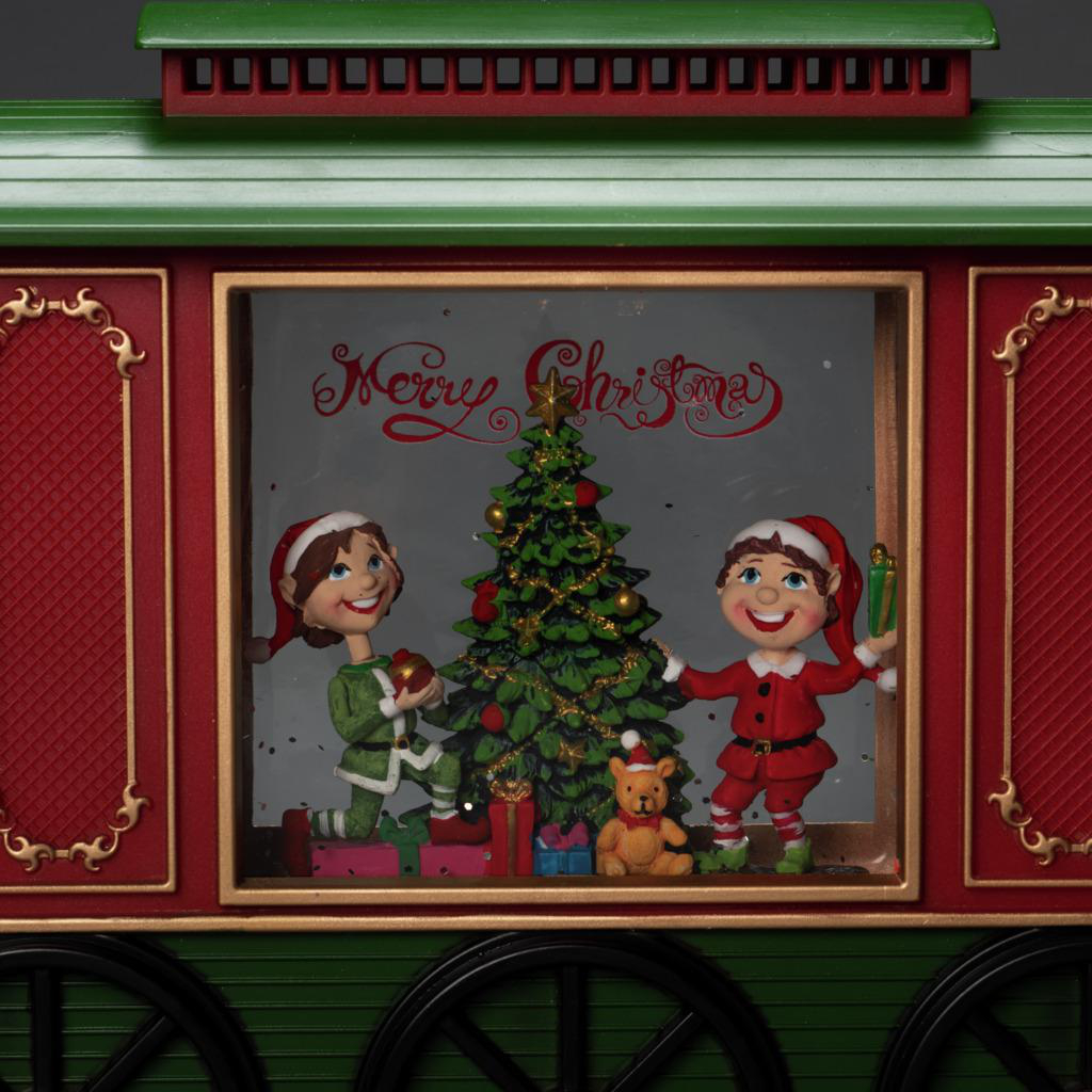 Eine Weihnachtszugwagen-Szene mit Elfen, Weihnachtsbaum, Geschenken und einem Teddybär im Inneren.