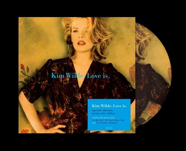 A 'Kim Wilde, Love is' album borítója. Egy nő sötét ruhában pózol. Fekete háttér.
