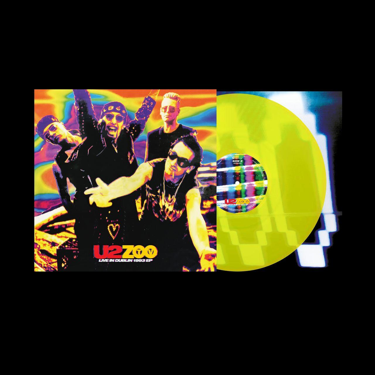 U2-Albumcover mit Bandmitgliedern und einer gelben Schallplatte.