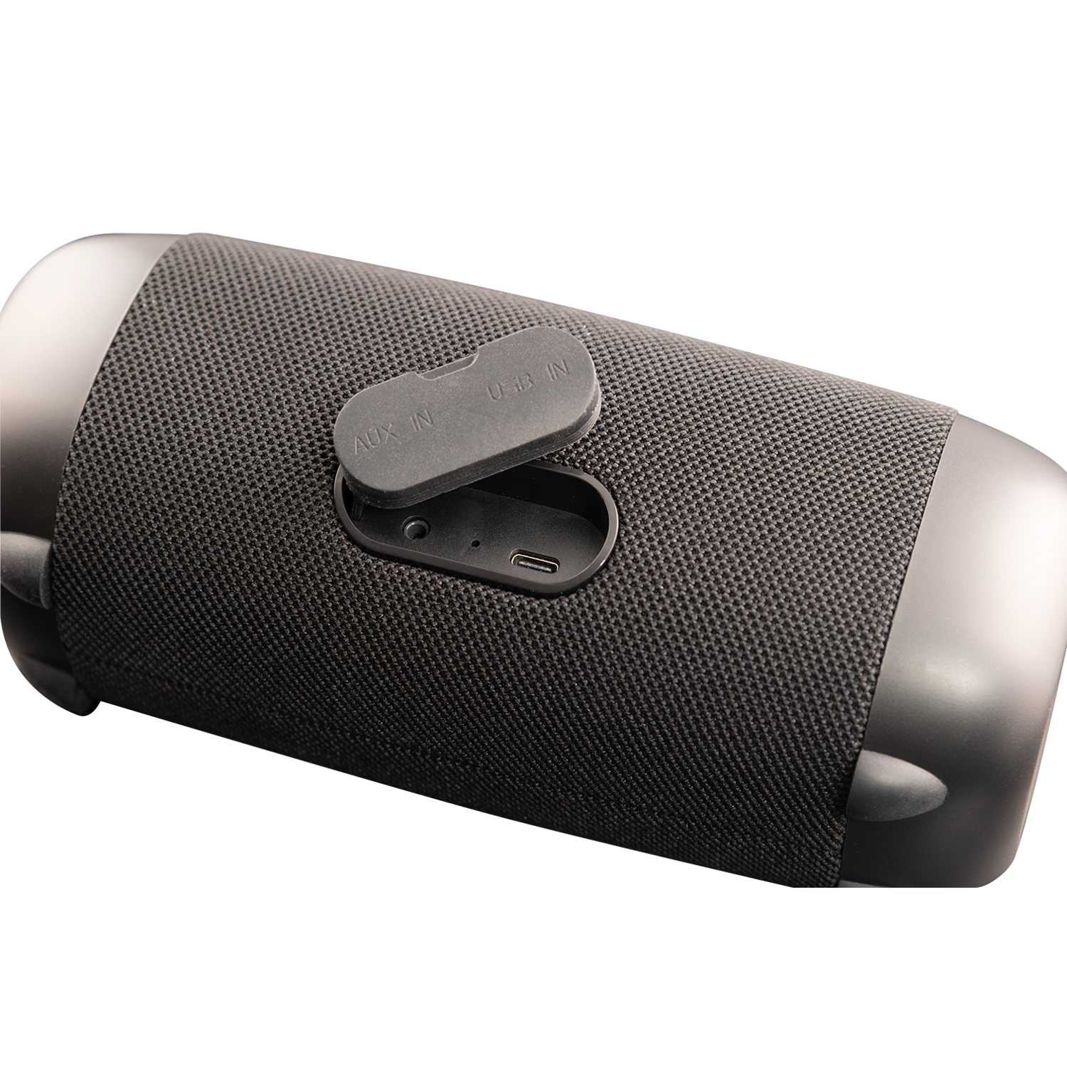 Black portable speaker with mesh fabric and a side panel with AUX IN and USB IN ports.
