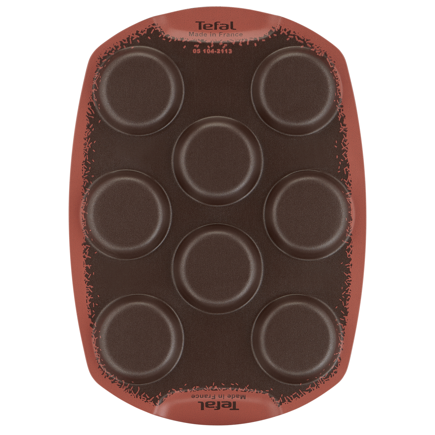 Un moule à pâtisserie en silicone marron avec sept cavités rondes.